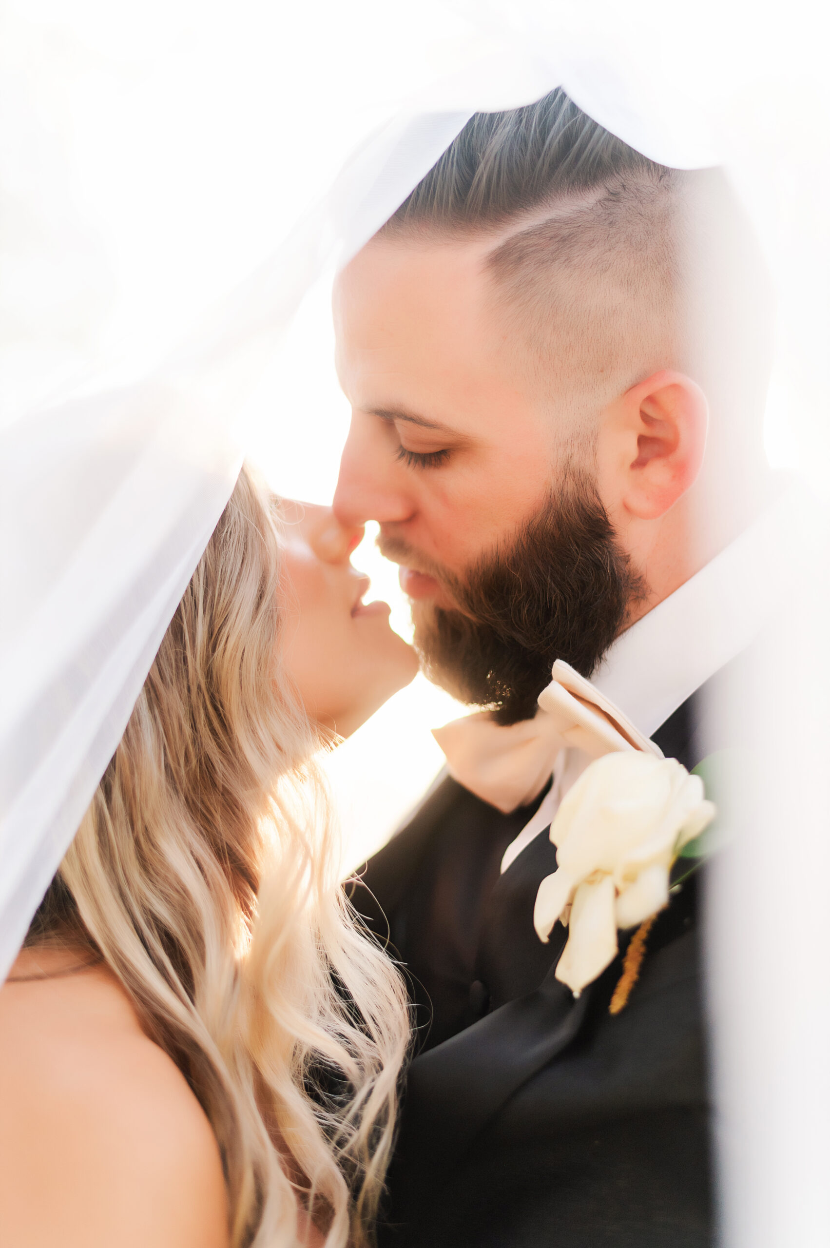 Bride and groom under a veil at The Plaza Hotel