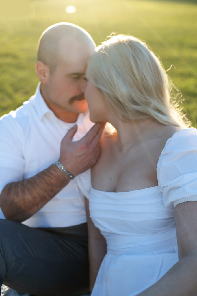 couple sitting on blanket nose to nose