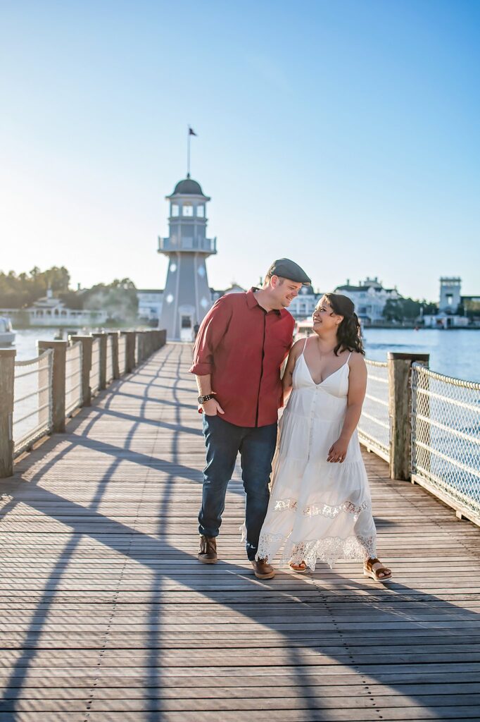 couple walking and laughing at their Disney Engagement Photos