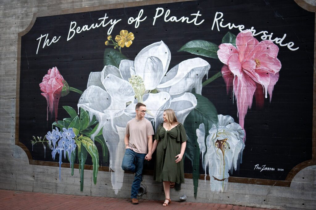 couple standing in front of grafitti wall