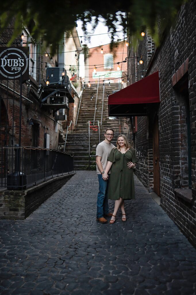 couple posed at river front at their savannah georgia engagement photos