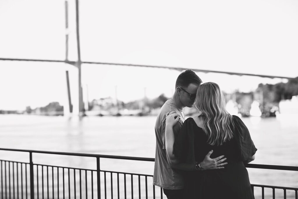 couple looking out over bridge at their savannah georgia engagement photos