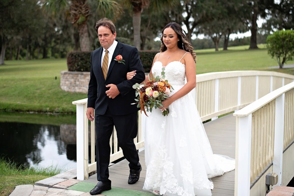 bride walking down the aisle with her dad