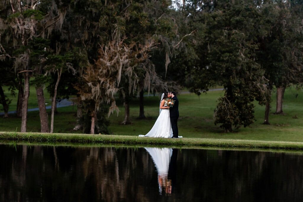 bride and groom in front of lake reflection photo Wedding photography styles