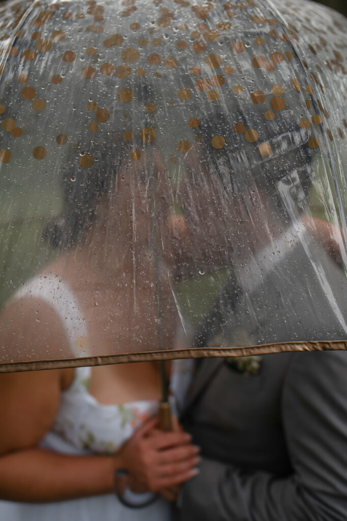 bride and groom under an umbrella creative wedding photos