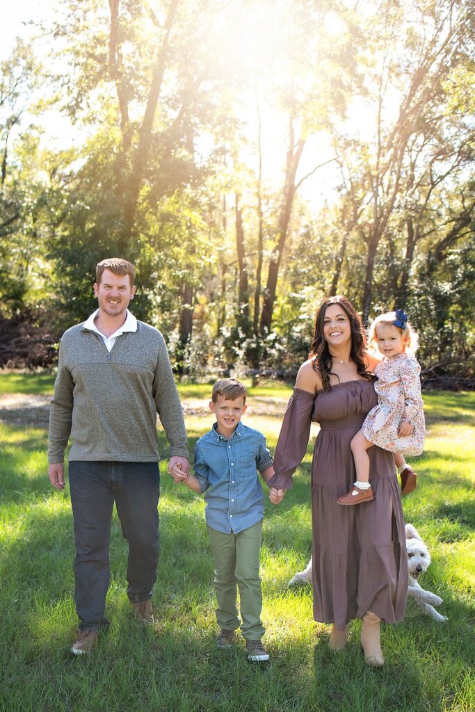 family holding hands and walking during golden hour