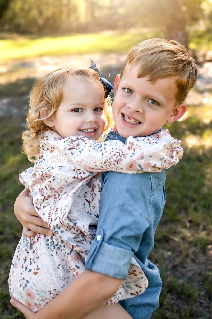 brother and sister holding each other 