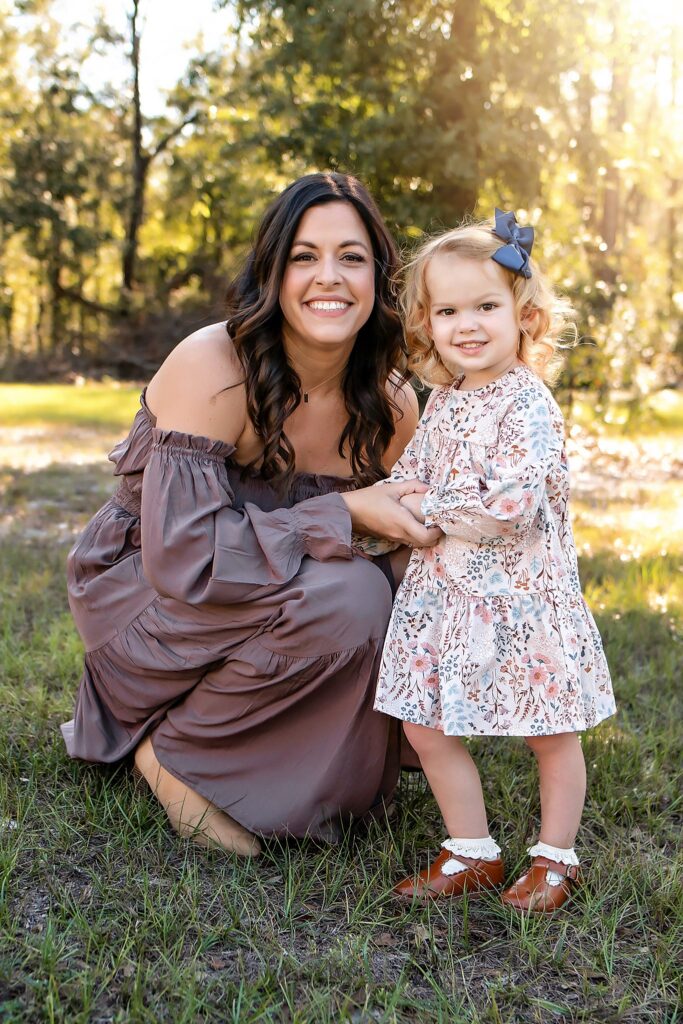 mother and daughter smiling at the camera