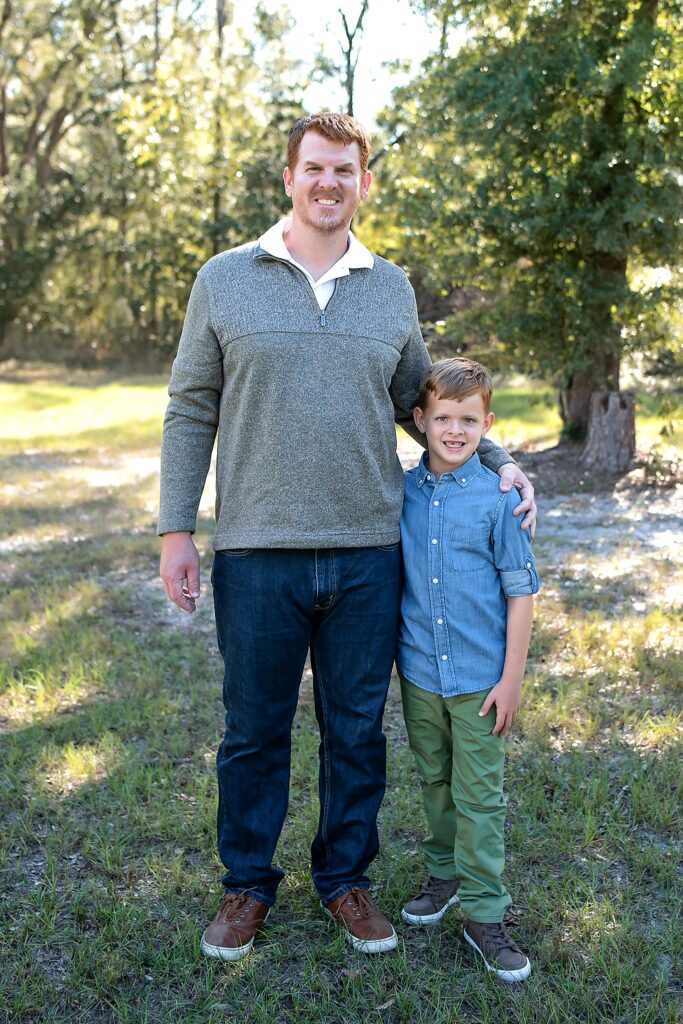 father and son smiling at the camera