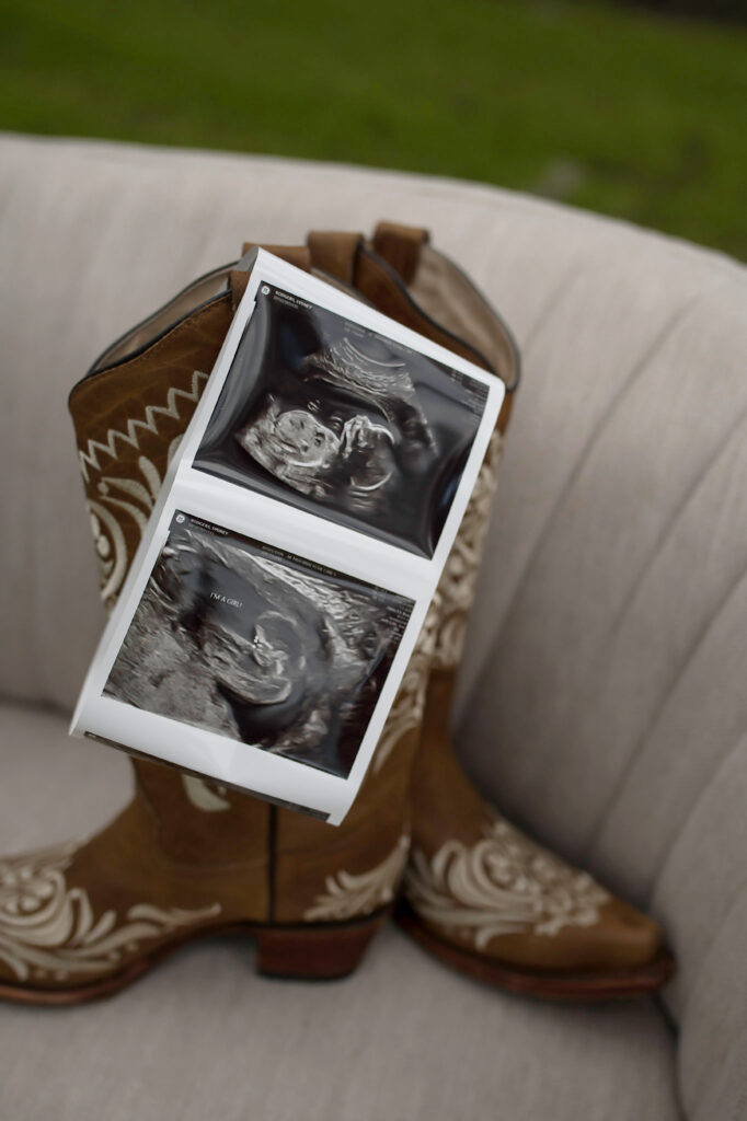 Pregnant woman cradling baby bump, illustrating when to book a maternity session.