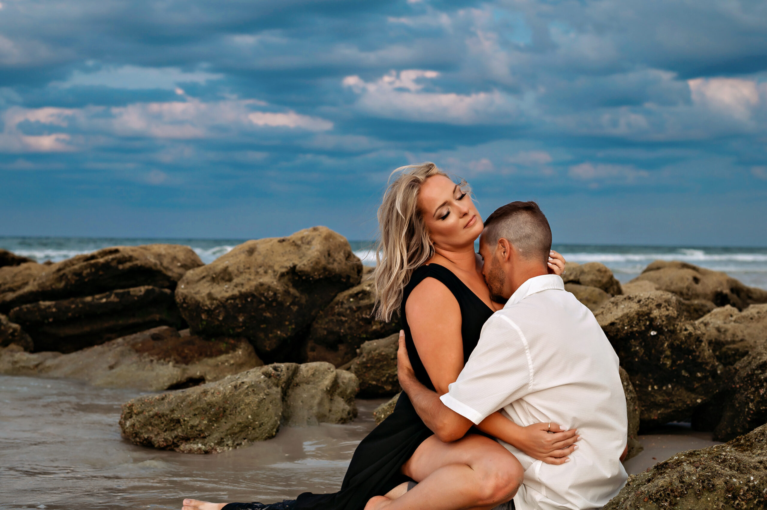 Couple walking hand-in-hand through the gardens during Washington Oaks engagement session.