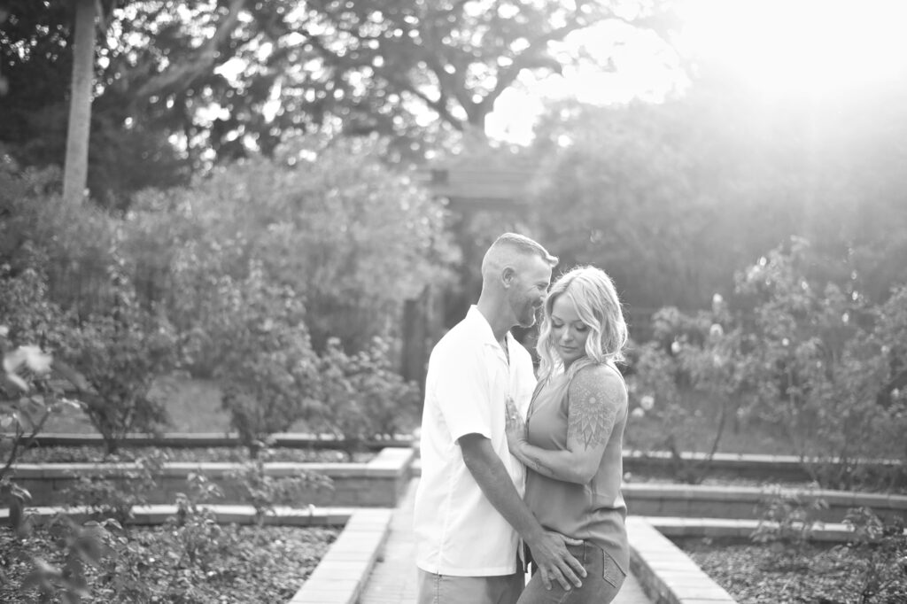 Lush greenery surrounding couple at Washington Oaks engagement session in the gardens.