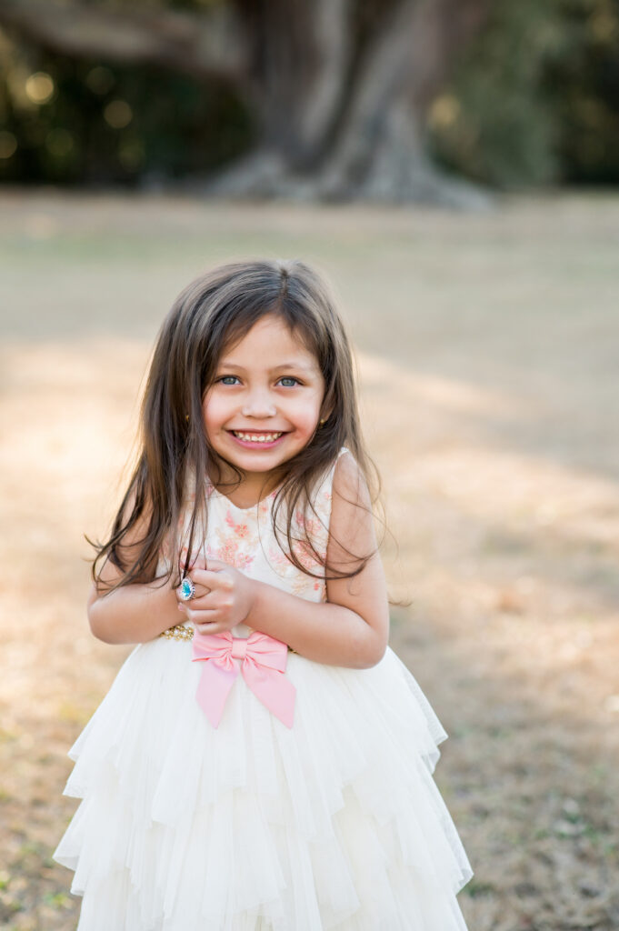 Little girl smiling during family photos at Cellon Oak Park Gainesville FL