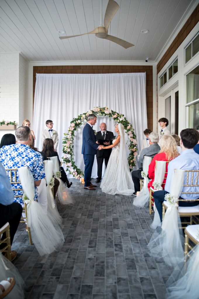 Nicole and Andy exchanging vows during their Atlantic Beach Florida intimate wedding ceremony in their backyard on Valentine’s Day