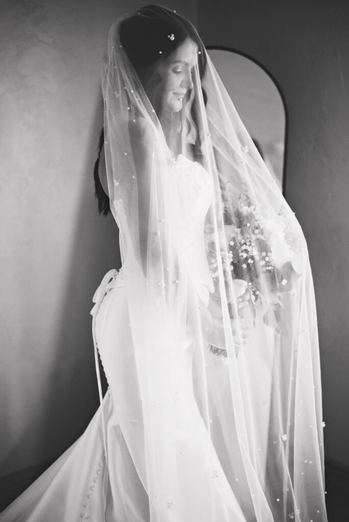 Bride posing under veil during Rustic Oaks Ranch wedding in October Florida